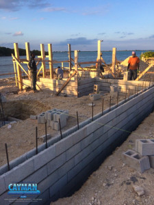 Construction of the concrete shell continues as crews place and secure blocks over the rebar supports. Cayman Structural Group is responsible for the foundation and shell construction and are the structural contractors for this luxury custom home.