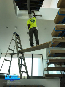 A crew member accesses the second floor stairs to apply coating.