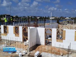 Crew members work on the second level of ICF wall reinforcement.
